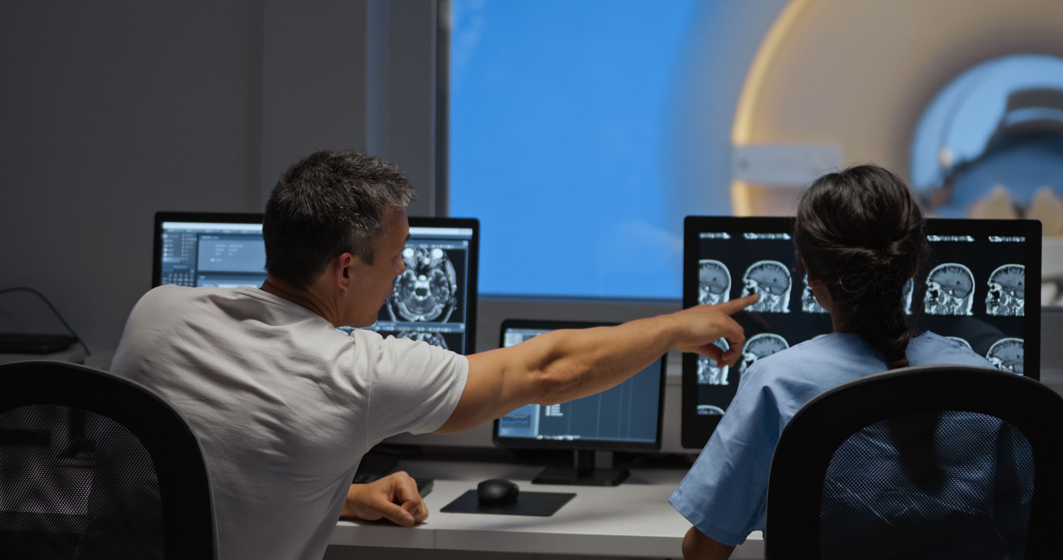 MRI technicians review test results preventative screening for health problems