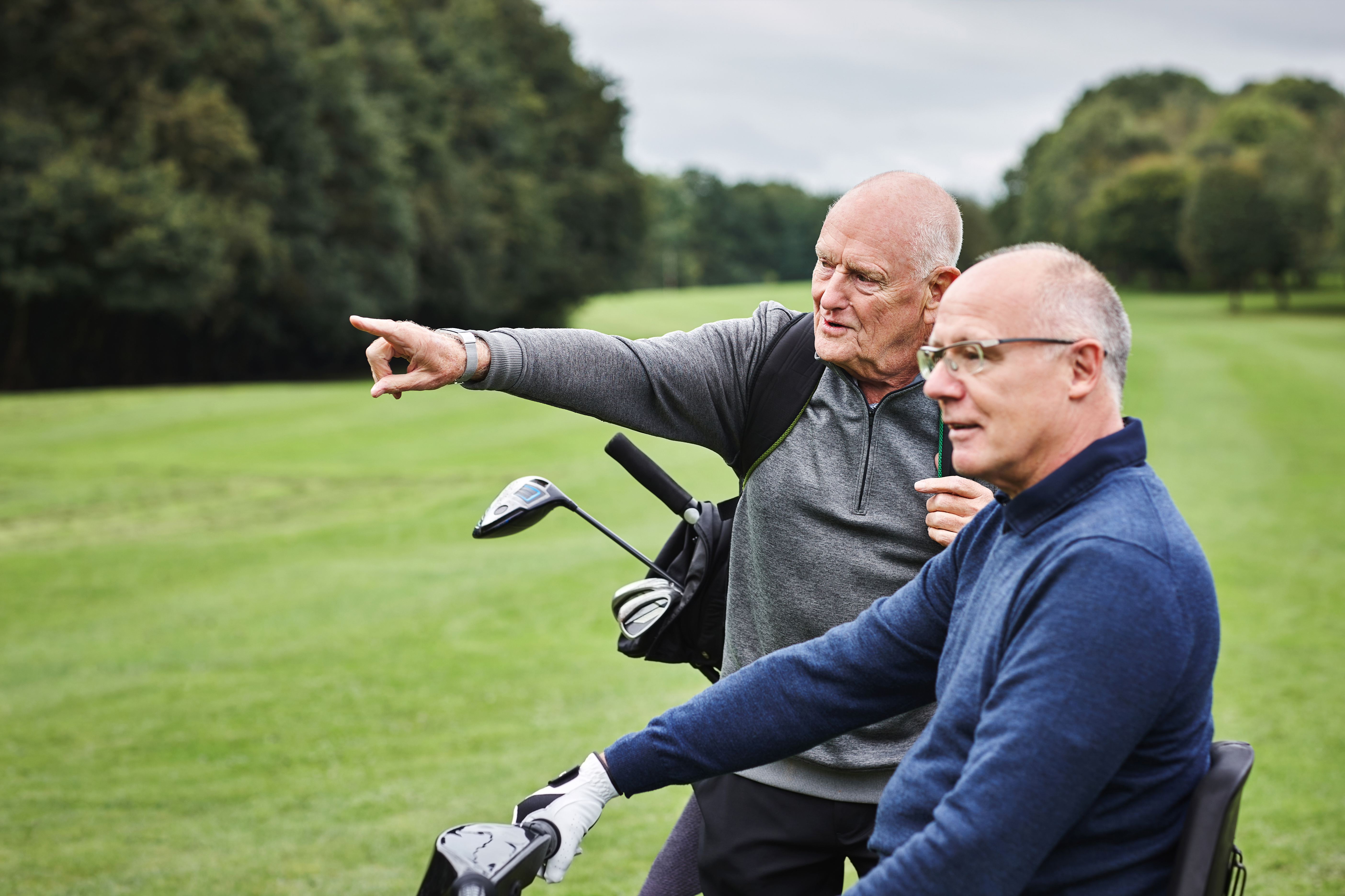 Middle-aged male professionals on the golf course enjoying an active, healthy lifestyle thanks to concierge care
