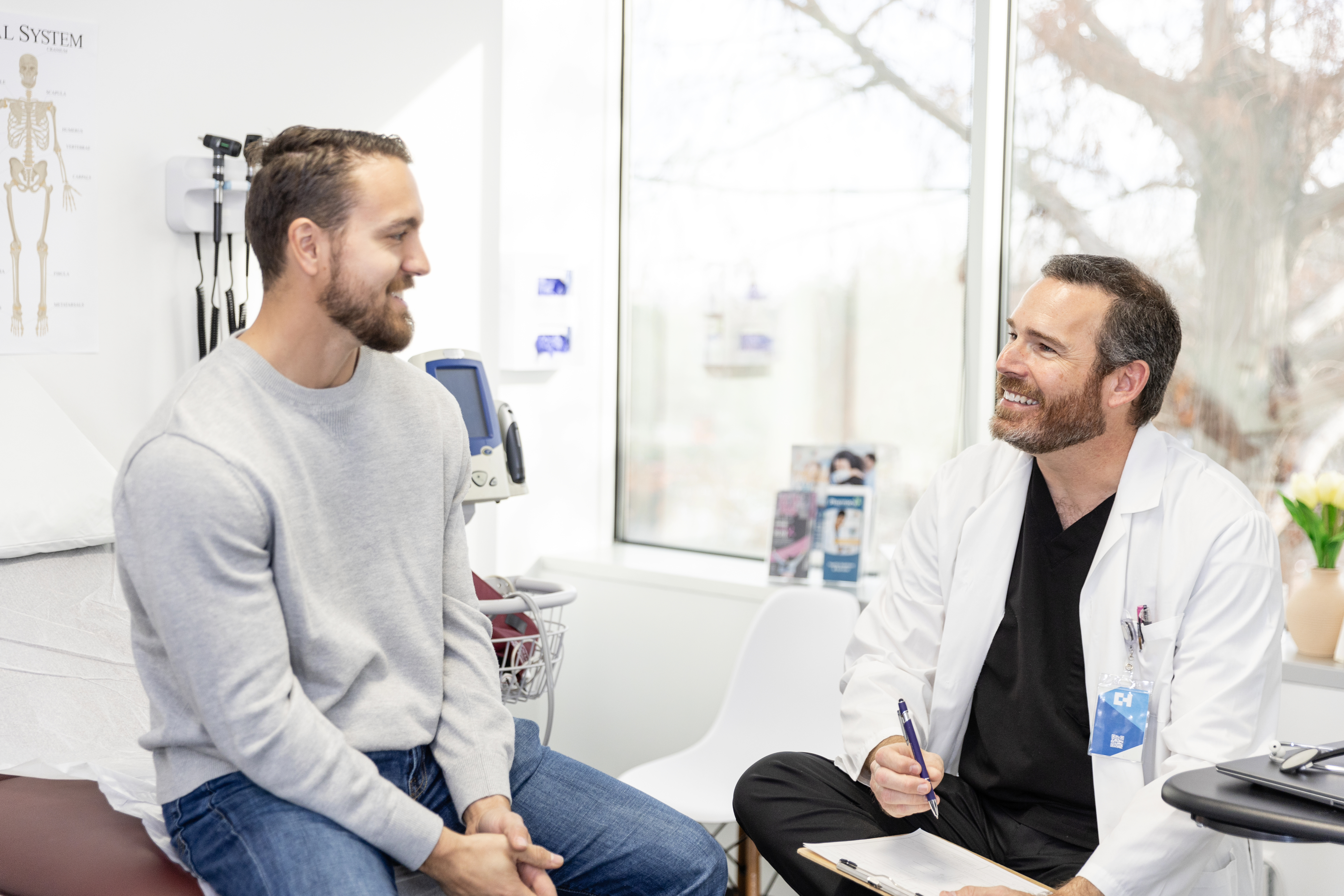 A doctor and his patient talking and smiling at each other