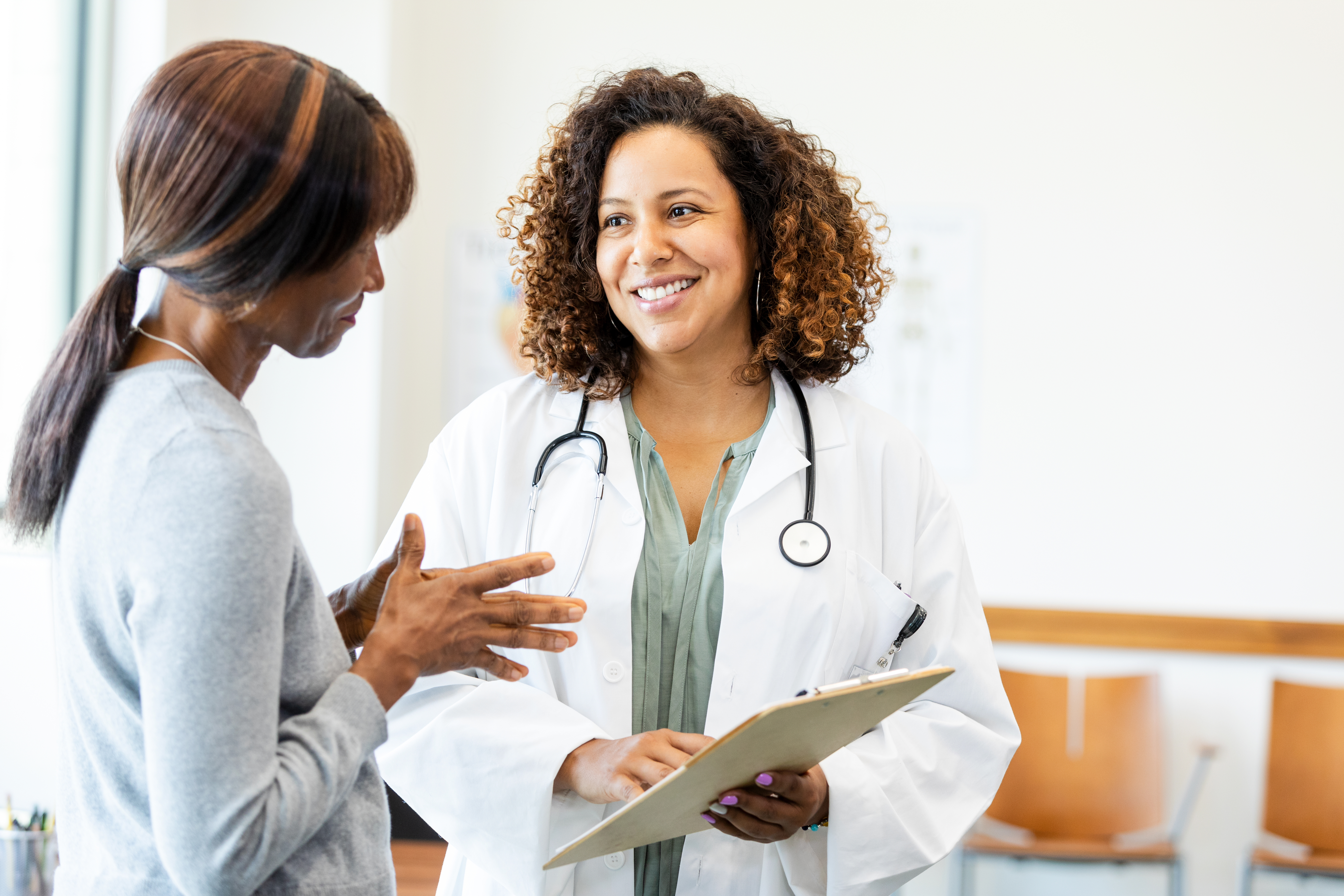 A smiling doctor speaking to her patient