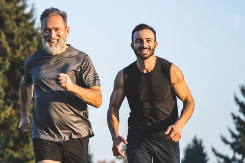 Middle-aged man exercises with his personal trainer