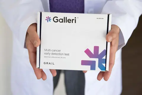 Hands holding a Galleri multi-cancer detection test box.