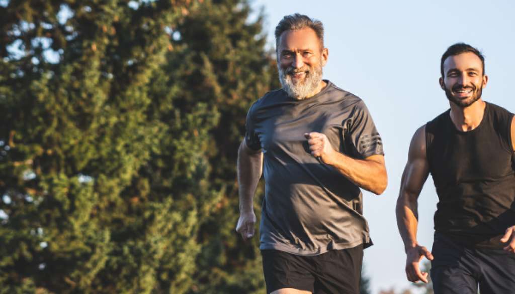 Middle-aged man exercises with his personal trainer