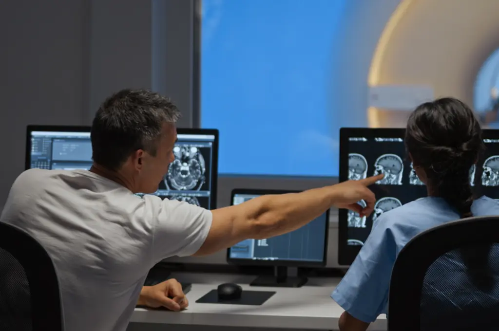 MRI technicians review test results preventative screening for health problems