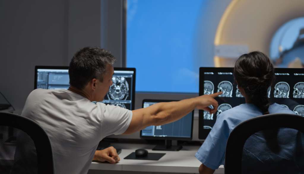 MRI technicians review test results preventative screening for health problems