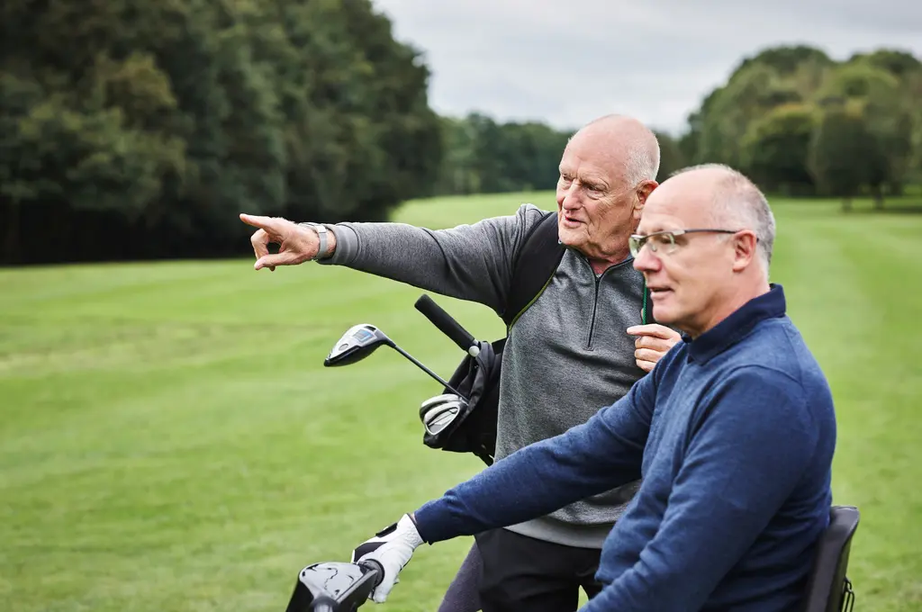 Middle-aged male professionals on the golf course enjoying an active, healthy lifestyle thanks to concierge care