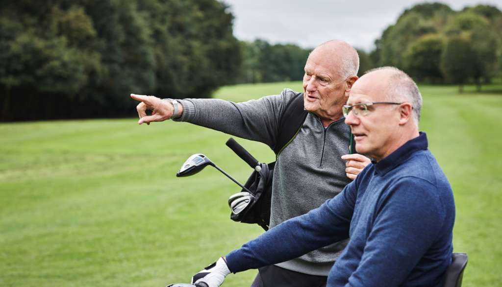 Middle-aged male professionals on the golf course enjoying an active, healthy lifestyle thanks to concierge care