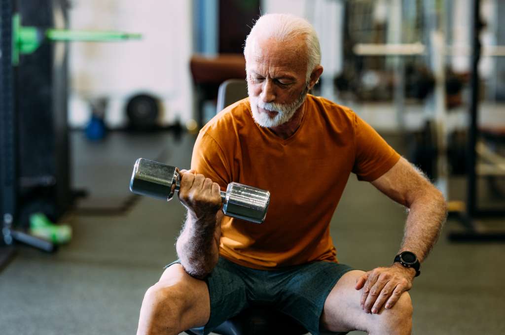A man at the gym, lifting a weight
