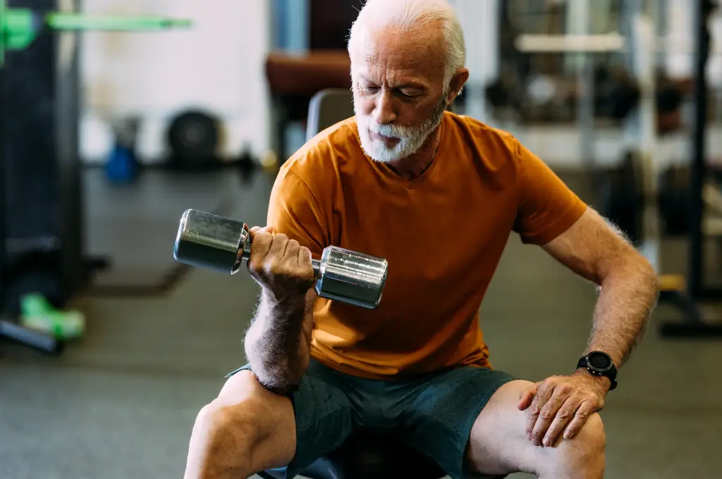 A man at the gym, lifting a weight