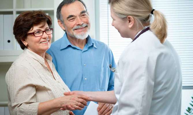 Three Rivers physician with middle aged St. Louis couple