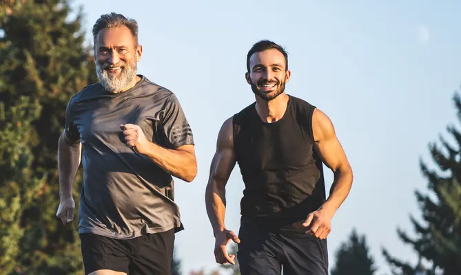 Middle-aged man exercises with his personal trainer