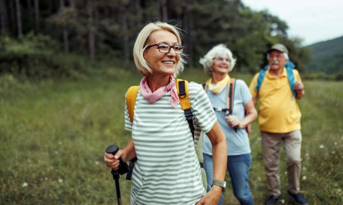 Happy elderly people on a hike