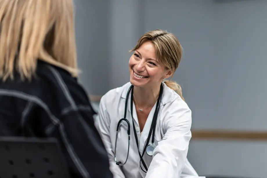 Concierge doctor smiling warmly at a patient.