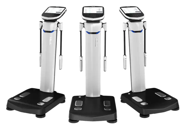Three body composition analyzers with digital screens and foot platforms.