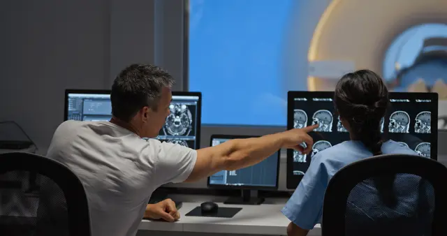 MRI technicians review test results preventative screening for health problems