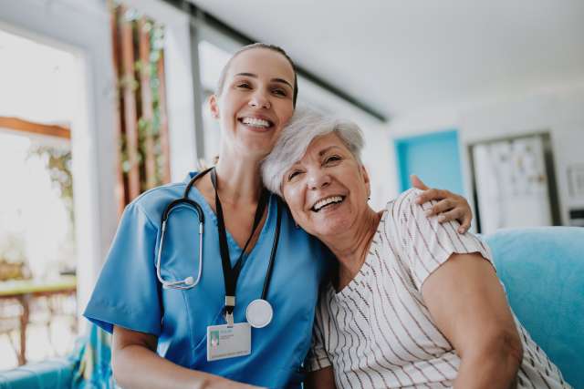 Doctor and patient hugging and supportive.