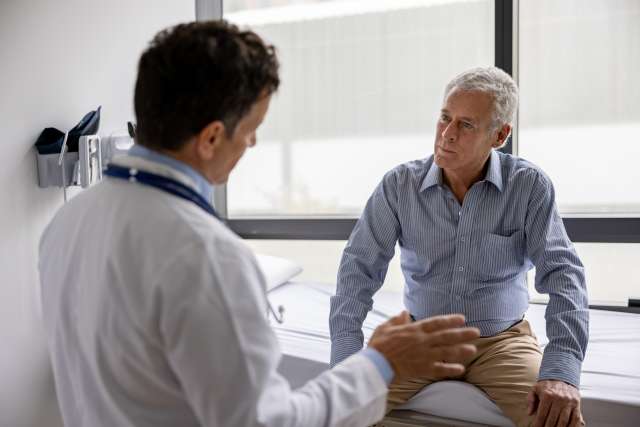 A doctor and a male patient in deep discussion