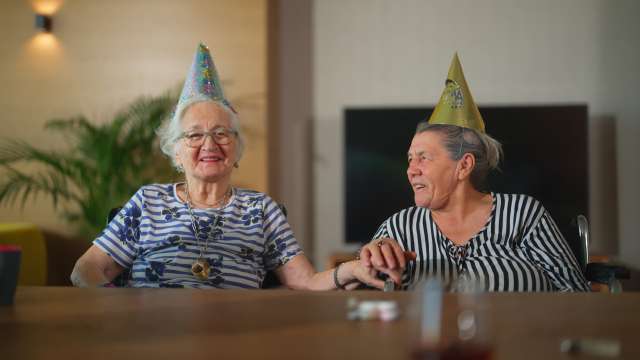 Two elderly women celebrating a birthday together