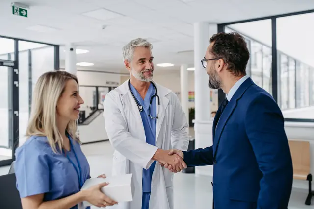 A doctor and a happy patient shaking hands
