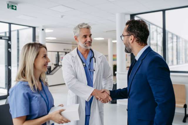 A doctor and a happy patient shaking hands