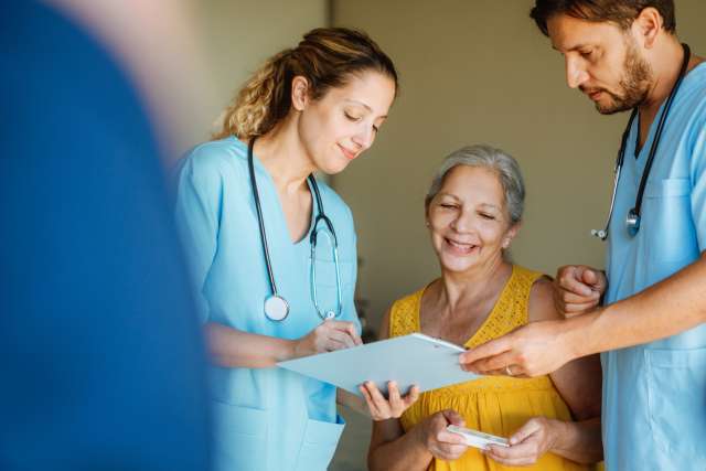 Woman smiling with her doctors