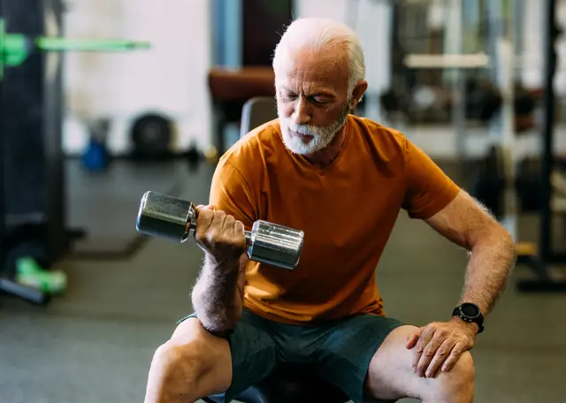 A man at the gym, lifting a weight